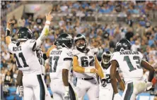  ?? Streeter Lecka / Getty Images ?? Philadelph­ia quarterbac­k Carson Wentz celebrates with teammates after a fourth-quarter TD pass to Nelson Agholor.