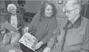  ?? SHARON MONTGOMERY-DUPE/CAPE BRETON POST ?? Tracy Wilson, centre, program assistant for the Cape Breton Regional Library, hands out handmade valentines to veterans at Taigh Na Mara including Mayme MacSween, left, and Arnold Jessome. The Reserve Mines and Dominion libraries hosted the Valentines...