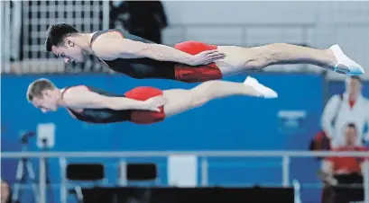  ?? GYMCAN PHOTO ?? Trampoline gymnast Nathan Shuh, foreground, competes at the 2019 world championsh­ips.