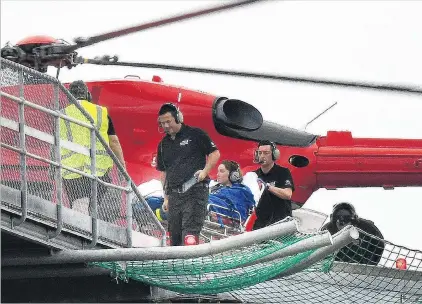  ?? PHOTO: STEPHEN JAQUIERY ?? Bitten by shark . . . A Frenchwoma­n is transferre­d from the Otago Regional Rescue helicopter to Dunedin Hospital yesterday.
