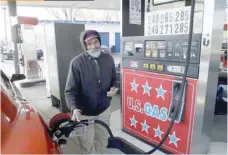  ?? — Reuters ?? A gas station attendant fills a customer’s vehicle in Turnersvil­le, New Jersey, in this file photo.