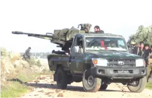  ?? (Reuters) ?? A SYRIAN army soldier fires a mounted weapon as troops advance on the town of Kfar Nabl on Monday.