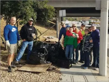  ?? Courtesy photo ?? Members of One Piece at a Time pose for a photo after a day of picking up litter along Lake Hughes Road in Castaic. The group of volunteers conducts regular trash pickups and beautifica­tion projects in Castaic.