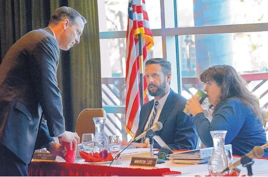  ?? JIM THOMPSON/JOURNAL ?? Athletic Director Eddie Nuñez talks with regents Rob Doughty and Marron Lee before the start of a Board of Regents meeting in April 2018.