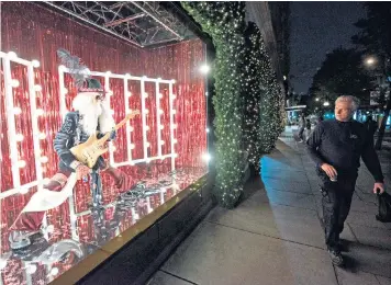  ??  ?? Rock bottom? Selfridges’ windows feature Santa writhing over a guitar