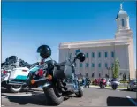  ?? JAMES M. DOBSON/THE SPECTRUM VIA AP ?? The Temple Riders, a faith-based motorcycle club visits the Cedar City Utah Temple as a stop on their biennial national rally Monday, June 11, 2018. The Temple Riders, a Mormon motorcycle club is holding its biennial gathering in southern Utah, where...