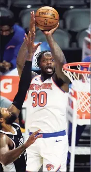  ?? Marcio Jose Sanchez / Associated Press ?? New York Knicks forward Julius Randle shoots over Los Angeles Clippers guard Paul George during the first half in Los Angeles on May 9.