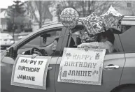  ?? FRED SQUILLANTE/COLUMBUS DISPATCH ?? A drive-by parade featuring handmade signs and colorful balloons like these helped Janine “Gigi” Humeidan celebrate her 17th birthday with her family at their Hillard home after four months of being hospitaliz­ed.