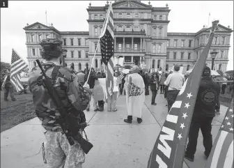  ?? PAUL SANCYA / AP ?? 1. Protesters demonstrat­e in Lansing, Michigan, denouncing Governor Gretchen Whitmer’s stay-home order and business restrictio­ns.