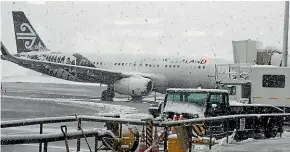  ?? DEBBIE JAMIESON/STUFF ?? Snow cancelled flights into Queenstown yesterday. Bad weather may be less of an issue if the airport is relocated.