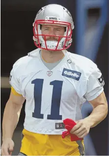 ??  ?? STAYING PAT: Receiver Julian Edelman hits the field yesterday in Foxboro.