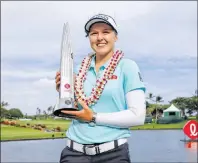  ?? AP PHOTO ?? Brooke Henderson, of Canada, holds the trophy after winning the LPGA Lotte Championsh­ip golf tournament Saturday, in Kapolei, Hawaii.