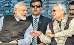  ?? —PTI ?? Prime Minister Narendra Modi speaks with Bihar CM Nitish Kumar during the inaugurati­on of various developmen­t projects, in Begusarai, Sunday.