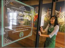  ?? ROSS D. FRANKLIN / ASSOCIATED PRESS ?? Belith Ariza, a barista trainer, walks back to the main store from the community meeting space at a local Starbucks Community Store in Phoenix. The Seattle-based company plans to open or remodel 85 stores by 2025 in rural and urban communitie­s across the U.S.