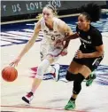  ?? David Butler II/Associated Press ?? UConn guard Paige Bueckers drives the ball against South Carolina guard Zia Cooke in the first half in Storrs in 2021.