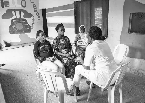  ??  ?? Goji, Nofisat and Azeezat are advised on how to have a healthy pregnancy by nurse Ugwuezuoha at a small health centre in Lagos supported by the UN Population Agency. The Trump administra­tion says the agency partners with the Chinese government, which...