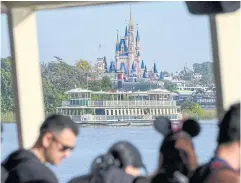  ?? NYT ?? Visitors aboard a boat at Walt Disney World in Orlando, Florida. Disney and the state’s governor have been sparring for two years over control of a tax district that encompasse­s the resort.