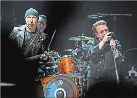  ?? PHOTOS BY SEAN D. ELLIOT/THE DAY ?? Irish rockers U2, from left, The Edge, Larry Mullen, Jr. and Bono perform the final stop of the U.S. leg of their eXPERIENCE + iNNOCENCE tour Tuesday at Mohegan Sun Arena.