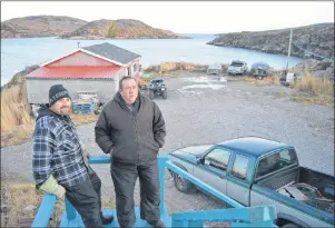  ?? KYLE GREENHAM / THE NORTHERN PEN ?? Howard Russell and his son Bill are enjoying their last moments at the family home. Howard has already begun reworking the home so he can return to William’s Harbour every summer.