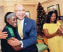  ?? PHOTOS BY RUDOLPH BROWN/ PHOTOGRAPH­ER ?? Governor General Sir Patrick Allen gives Reggae Girlz captain Konya Plummer a hug, while Lady Allen looks on after presenting a certificat­e of recognitio­n to the Girlz during a courtesy call at King’s House.