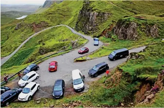  ??  ?? Take the high road: Cars park in passing places near beauty spot The Quiraing