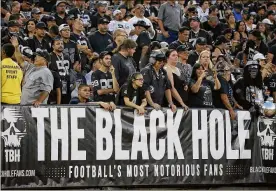  ?? ERIC RISBERG / AP ?? Above: Raiders fans watch from the Black Hole section of Oakland Alameda County Coliseum.