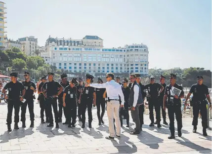  ?? Markus Schreiber, The Associated Press ?? French police officers receive instructio­ns Thursday in front of the Le Bellevue at the beach promenade before the Group of Seven summit begins this weekend in Biarritz, a seaside city on France’s southwest coast.