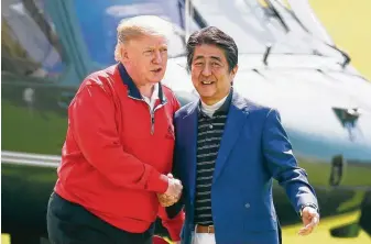  ?? Kimimasa Mayama / Associated Press ?? Japanese Prime Minister Shinzo Abe welcomes President Donald Trump today at Mobara Country Club, south of Tokyo. The U.S. and Japan are negotiatin­g a bilateral trade deal.