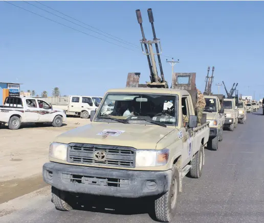  ??  ?? Military vehicles belonging to the internatio­nally recognized Libyan government head out to the front line from Misrata, Libya, Feb. 3, 2020.