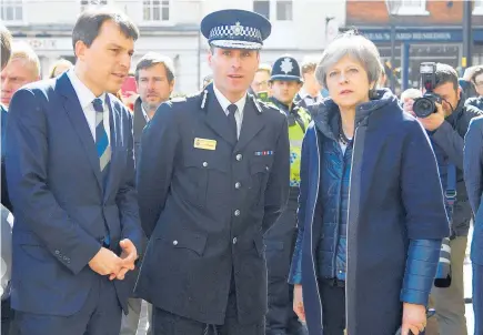  ?? Picture / AP ?? Theresa May met with officials yesterday as she visited Salisbury, the city where Sergei Skripal and his daughter Yulia were poisoned.
