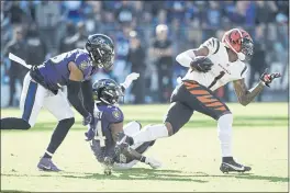  ?? GAIL BURTON — THE ASSOCIATED PRESS ?? Baltimore Ravens safety Chuck Clark (36) and cornerback Marlon Humphrey (44) miss a tackle of Cincinnati Bengals wide receiver Ja’Marr Chase (1) before he took off for a long touchdown on a reception during the second half Sunday in Baltimore.