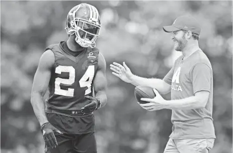  ?? PATRICK MCDERMOTT, USA TODAY SPORTS ?? Dale Earnhardt Jr., right, got his car fixed just in time to give Redskins cornerback Josh Norman a ride at Richmond Raceway.