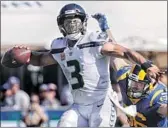  ?? Robert Gauthier Los Angeles Times ?? SEATTLE’S RUSSELL WILSON figures to be a handful for Matt Longacre and the Rams.