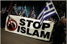  ?? (Reuters) ?? SUPPORTERS OF Greece’s far-Right Golden Dawn party hold a banner during a protest against Turkey, in Athens on March 5.