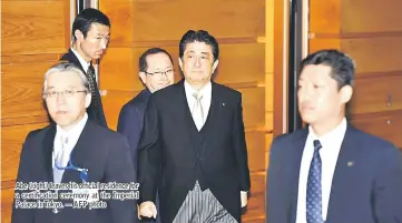  ??  ?? Abe (right) leaves his official residence for a certificat­ion ceremony at the Imperial Palace in Tokyo. — AFP photo