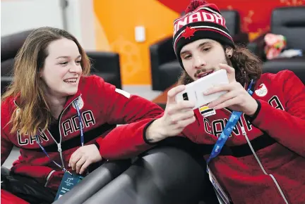  ?? MARTIN BERNETTI/AFP/GETTY IMAGES ?? Canada’s short track gold medallist Samuel Girard and Canada’s short track bronze medallist Kim Boutin chat backstage during the medal ceremonies Sunday. Short track has become the sport most likely to bring in medals for Canada.