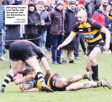  ?? PICTURE: Orrell RUFC ?? Still going: Orrell’s Leon Harber hits the ground with Jos Winstanley in support