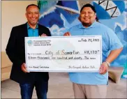  ?? LOANED PHOTO ?? J. Deal Begay Jr. (right), Cocopah Tribal Council vice chairman, presents a check for $11,170 to Somerton Mayor Jose Yepez, to support the city’s programs for seniors and youth. Each year, Native American casinos throughout Arizona donate a percentage...
