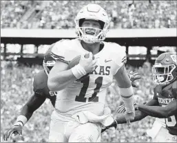  ?? RONALD MARTINEZ/GETTY ?? Sam Ehlinger smiles as he scores the first of his three rushing touchdowns for Texas.