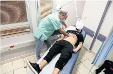  ?? REUTERS ?? A patient suffering from long Covid is examined in a post-coronaviru­s disease clinic at Ichilov Hospital in Tel Aviv, Israel on Feb 21, 2022.