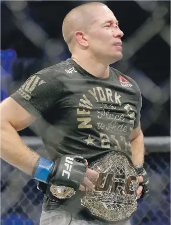  ?? MIKE STOBE/GETTY IMAGES ?? Canadian UFC star Georges St-Pierre admits he had difficulty gaining the weight necessary to fight for the middleweig­ht title, a bout he won against Michael Bisping Saturday in New York.