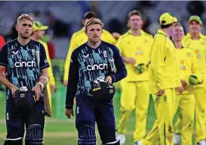  ?? Picture: Asanka Brendon Ratnayake/AP/REX/Shuttersto­ck ?? England’s David Willey and Olly Stone walk off as Australia’s players celebrate their win in yesterday’s one-day internatio­nal at the Melbourne Cricket Ground