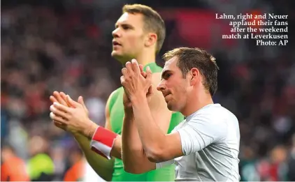  ?? Photo: AP ?? Lahm, right and Neuer applaud their fans after the weekend match at Leverkusen