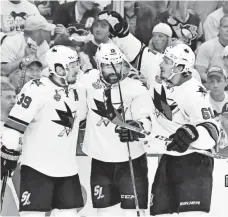  ?? CHARLES LECLAIRE, USA TODAY SPORTS ?? Sharks teammates, from left, Logan Couture, Patrick Marleau and Justin Braun celebrate a goal in Thursday’s victory.