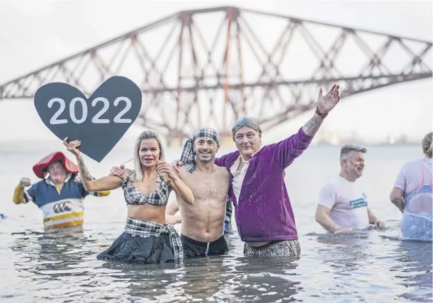  ?? ?? ↑ Members of the public braved the cold waters in the Forth this year despite the official event being cancelled