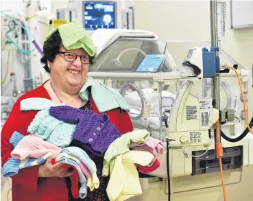  ?? PHOTO: PETER MCINTOSH ?? Knitted gifts . . . Riversdale Lions Club member Heather Fowler shows off some of the creations given to the Dunedin Hospital’s neonatal intensive care unit.