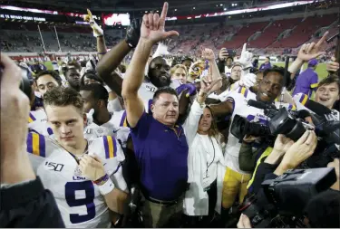  ?? JOHN BAZEMORE — THE ASSOCIATED PRESS FILE ?? FILE - In this Nov. 9, 2019, file photo, LSU head coach Ed Orgeron celebrates with his players after defeating Alabama 46-41 in an NCAA college football game in Tuscaloosa, Ala.