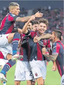  ?? ?? Aaron Hickey (second right) is mobbed by his Bologna teammates after scoring against Genoa