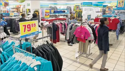  ?? PHOTO: BLOOMBERG ?? Customers shop for garments at a Pepkor store in Johannesbu­rg. Steinhoff, which acquired the local retailer last year, says it will increase its growth trajectory by enabling the group to expand its footprint in the discount market.