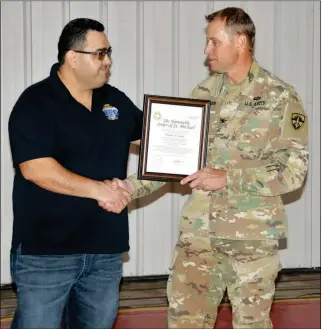  ?? YUMA PROVING GROUND PHOTOS ?? ABOVE: Yuma Proving Ground Commander Col. Ross Poppenberg­er (right) presents civilian employee Walter Lopez with a certificat­e during his induction into the Order of Saint Michael on Wednesday. Lopez is the 11th person from YPG to receive the prestigiou­s award.